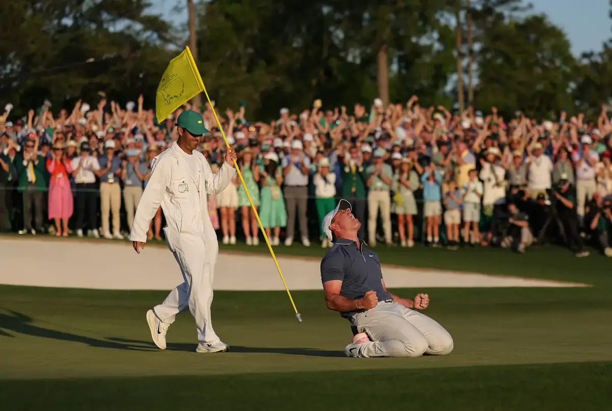 Champion receiving the green jacket from a past winner at the traditional ceremony